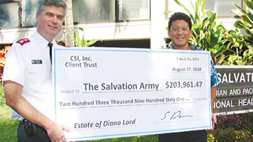 Salvation Army officer holds big check.