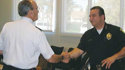 Commissioner Saunders greets Police Chief.