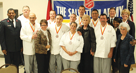 Divisional Leaders Majors Bill and Lisa Dickinson, Jr. (top right) join Corps Officers Captains Martin (far left) and Tory (second row right) Ross and Chef Barry Crall (to Martin Ross’s left) to con-gratulate the graduates.  	Photo by Sydney Fong