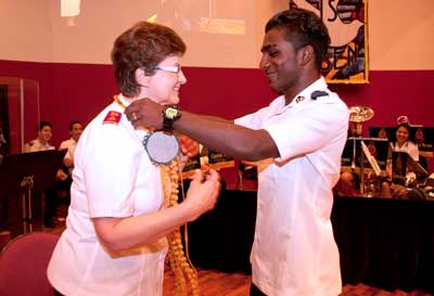 General Linda Bond is presented with a sandalwood garland by Kishan from the Tamil fellowship from Eratchipuu Corps, Singapore