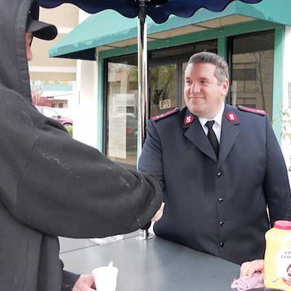 Yuba-Sutter Corps Officer Captain Thomas Stambaugh greets a visitor to the coffee cart.           Photo by Chaya Galicia