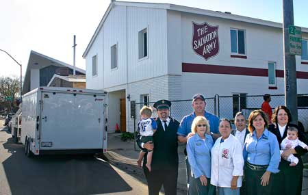 Lts. Paul and Jennifer Swain and staff members at the corps' new location