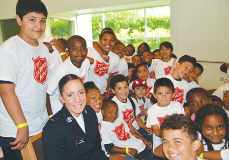 Cadet Naomi Kuhlman with kids from Seattle White Center’s summer day camp.Photo by Kevin Pontsler