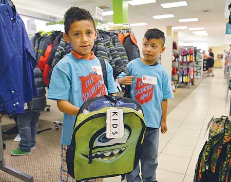 Brady Chavez (l) and Yahir Inocencio, along with other Seattle White Center area children, select  back-to-school items at JCPenney. Photo by Kevin Pontsler