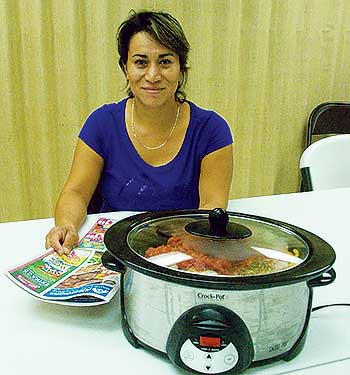 Eva Rodriguez learns about preparing healthy meals in a crock pot.                   Photo by Les Spousta