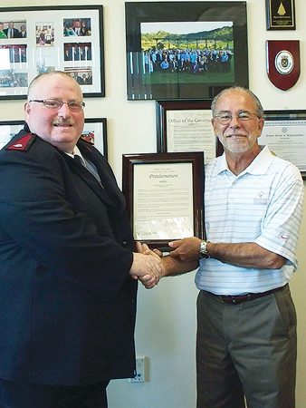 Mayor Mark Nexsen presents Major Larry Feist with the official proclamation of “Major Larry Feist Day.”           Photo by Julie E. Feist