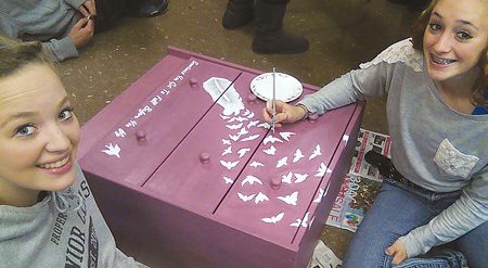 High school art students decorate drawers for the fundraiser. Photo by Brenda Fries
