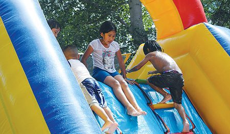 Children enjoy the inflatable slide at the Latino Family Camp.Photo courtesy of Salvador Gonzalez