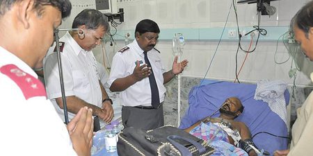 Salvation Army officers pray for a victim of the bombings. Photo courtesy of Salvation Army Pakistan