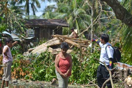Major Ronaldo Banlasan Corps Officer of La Paz Corps surveying the damage in Iloilo Province on the island of Panay