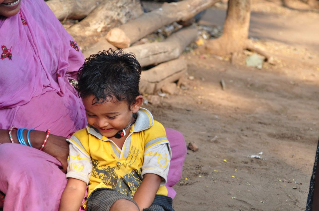 Child smiling mothers lap