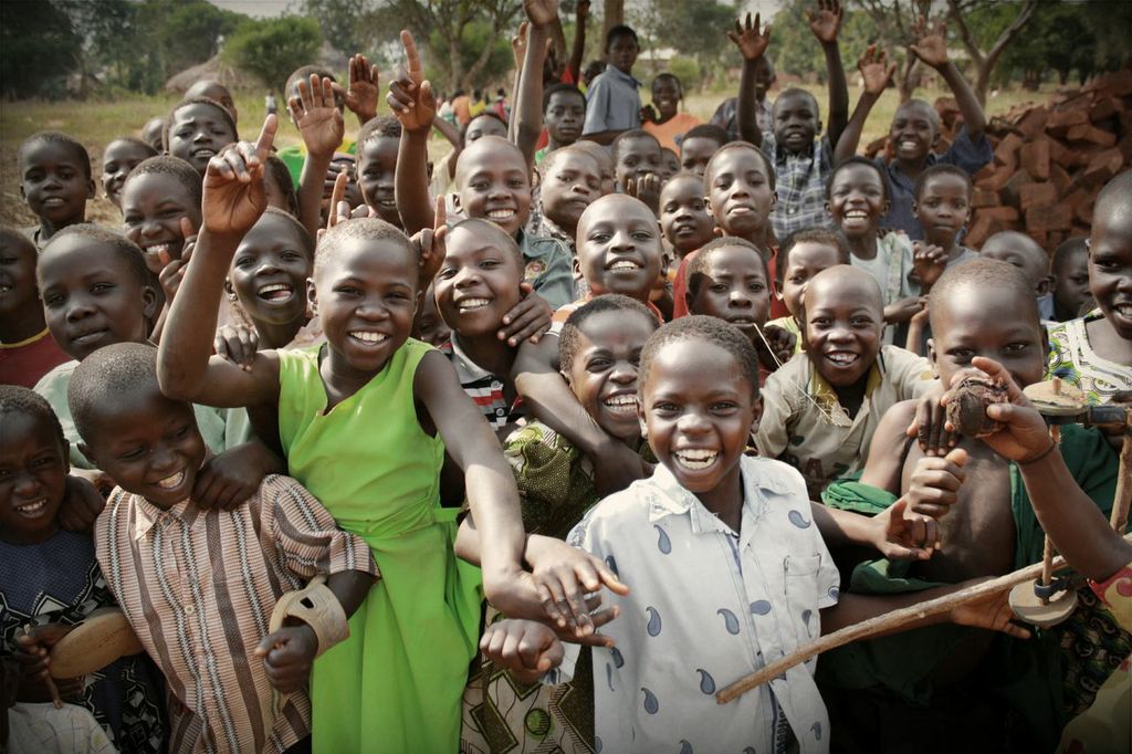 Group of kids smiling outside