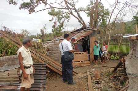 Salvation Army officer in Antique visiting a community in makeshift homes that were damaged by Typhoon Haiyan