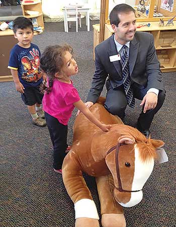 Philip Tringali, Wells Fargo bank manager in Carmel, Calif., personally presents “Mac” to The Salvation Army Child Development Center in Monterey.             Photo by  Solange Hansen