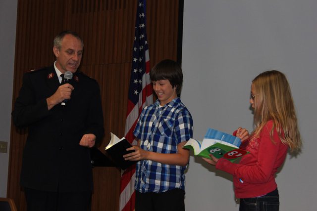 Major Kyle Smith with Elias Markham and Charity Kaptain.Major Kyle Smith with Elias Markham and Charity Kaptain.