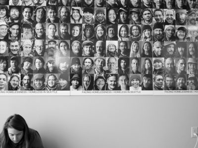 A volunteer works in front of a portrait of individuals facing homelessness | Photos courtesy of Hack To End Homelessness