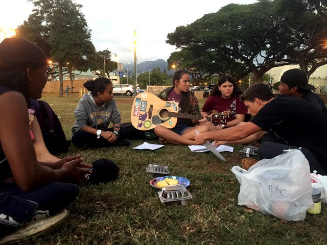 Team members minister in a park frequented by individuals experiencing homelessness.