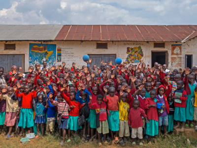 Children in Uganda smile on with the visit of One World Play Project. Photo By One World Play Project