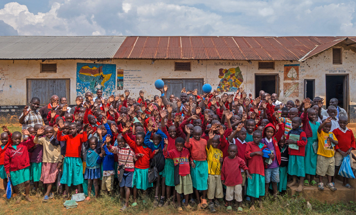 Children in Uganda smile on with the visit of One World Play Project. Photo By One World Play Project