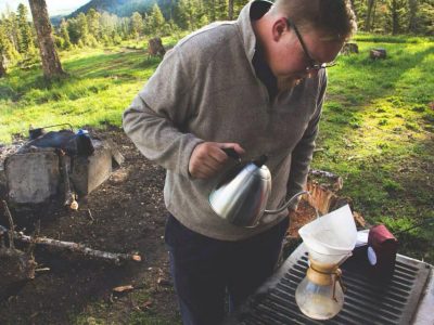 GoodWorks Coffee & Tea Founder Sam Cornthwaite making a cup of coffee overlooking the Bridger Mountain range in his home state, Montana.