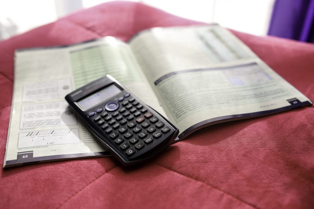 textbook and calculator on blanket