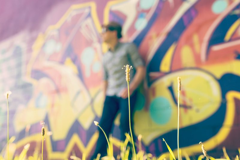 Man standing in front of graffiti wall
