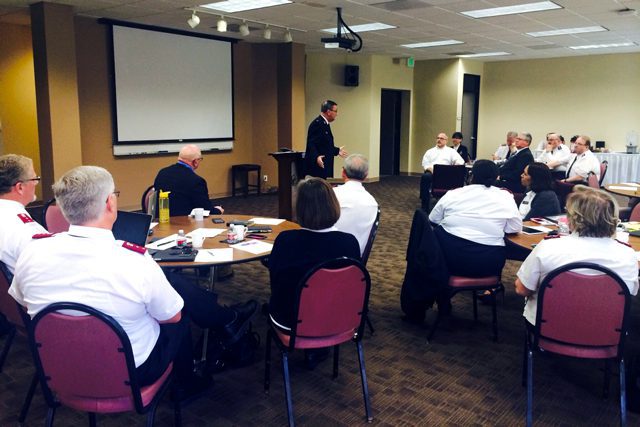 Western Territorial Commander Commissioner James Knaggs addresses delegates of the recent social service caucus.