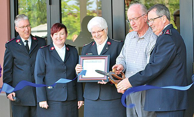 Territorial leaders Commissioners James and Carolyn Knaggs, longtime Advisory Council members, local Chamber of Commerce members, and Corps Officers Majors James and Laura Sullivan cut the ribbon to officially open the doors to the new social services center.