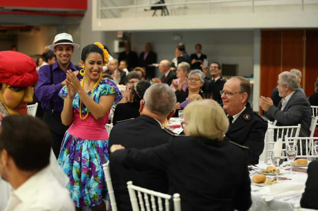 General André Cox enjoys traditional cuisine and lively salsa music and dancing during a luncheon in his honor on a visit to the Puerto Rico and Virgin Islands Division.