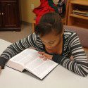 Child reading Bible