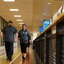 two people walking down hallway