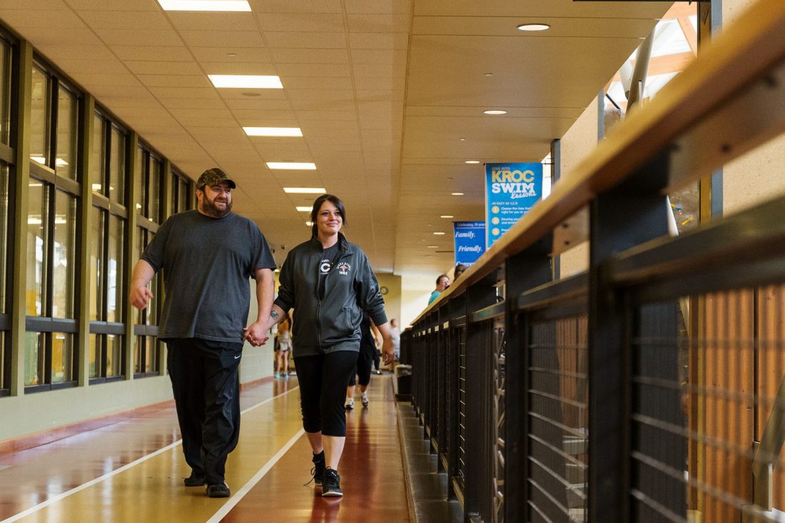 two people walking down hallway