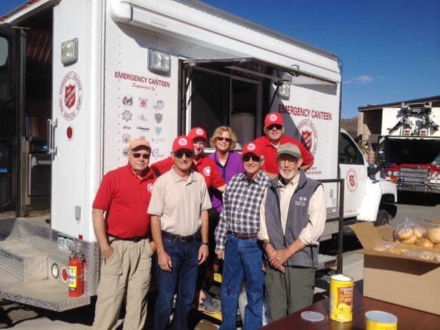 Men and Women standing in front of van