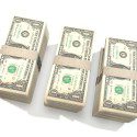 Thee stacks of dollar bills