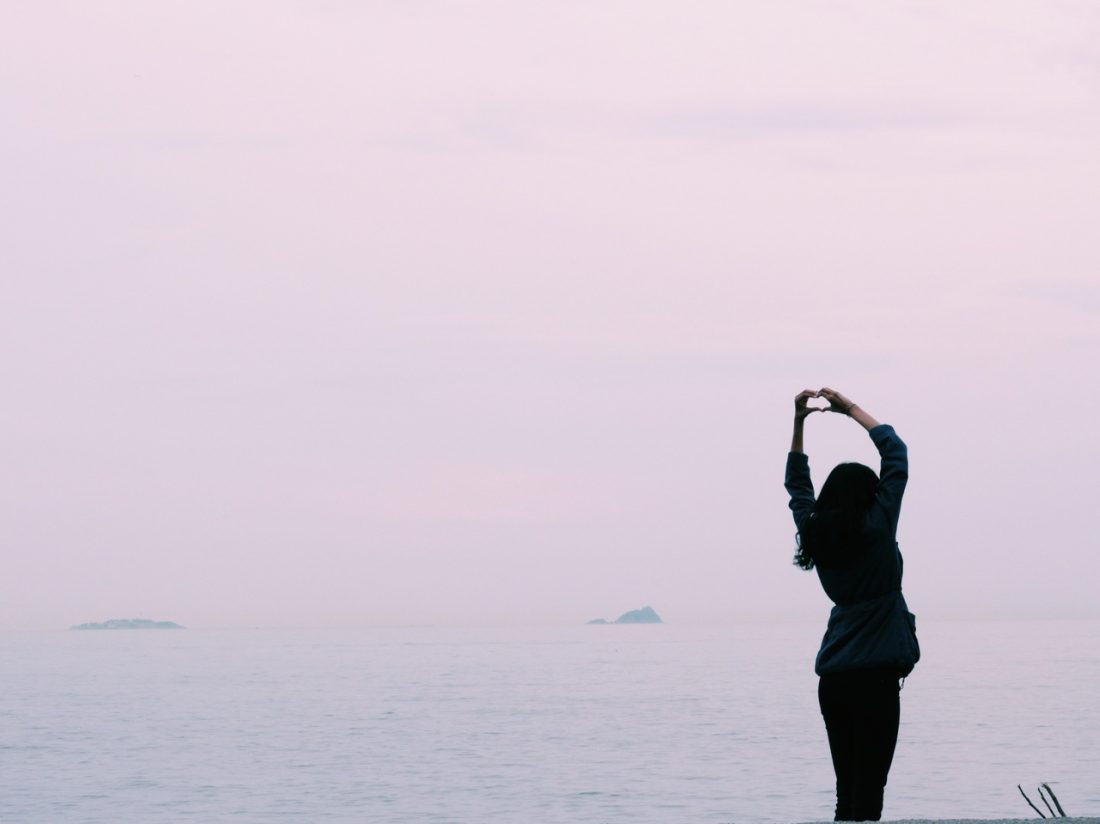 Person stretching in front of water