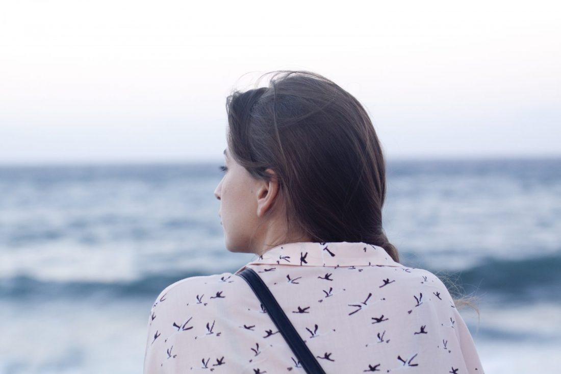 Woman looking out at ocean