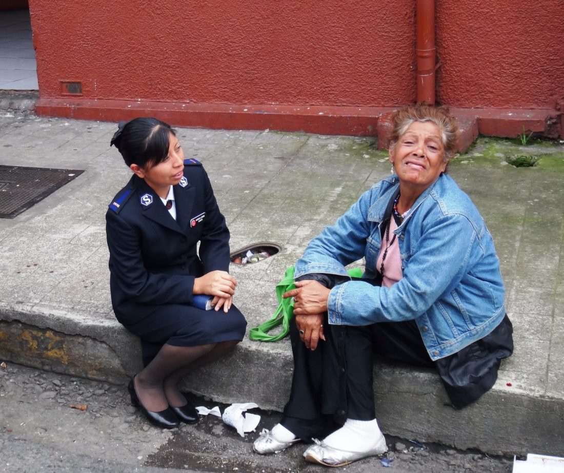 Officer with woman on street