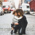 Mother and Daughter hugging in street