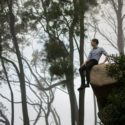 Man sitting on edge of cliff
