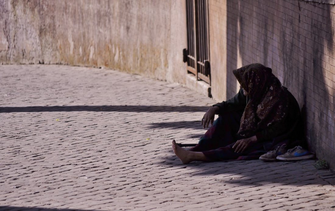 person without shoes sitting outside