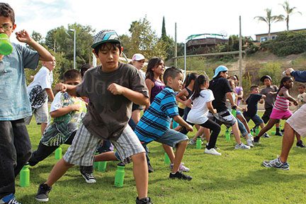 group of children stretching outside 