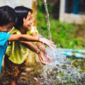 children playing with water outside