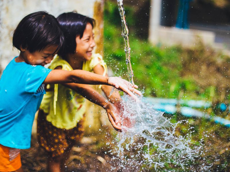 children playing with water outside