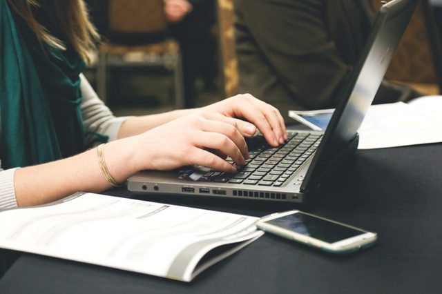 person typing on laptop