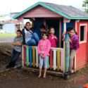 Children standing outside playhouse