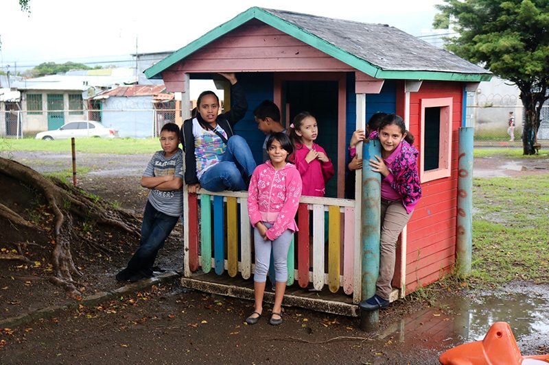 Children standing outside playhouse