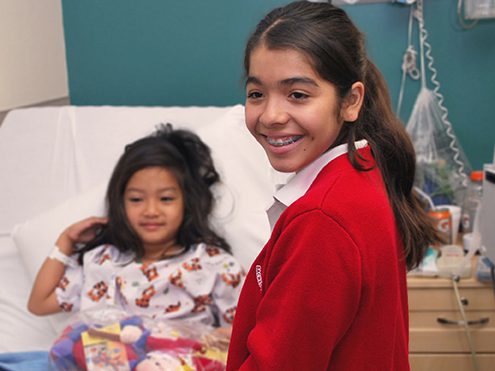 Two young girls smiling