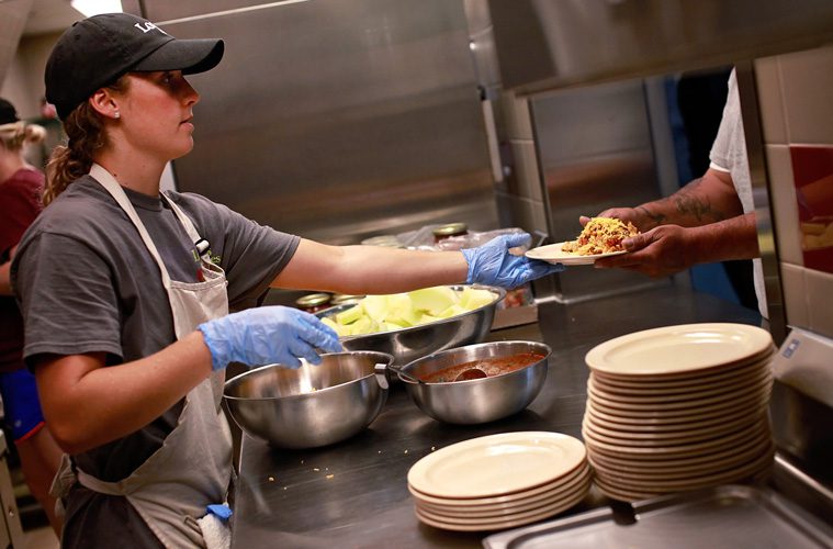 EDS volunteer serving meals