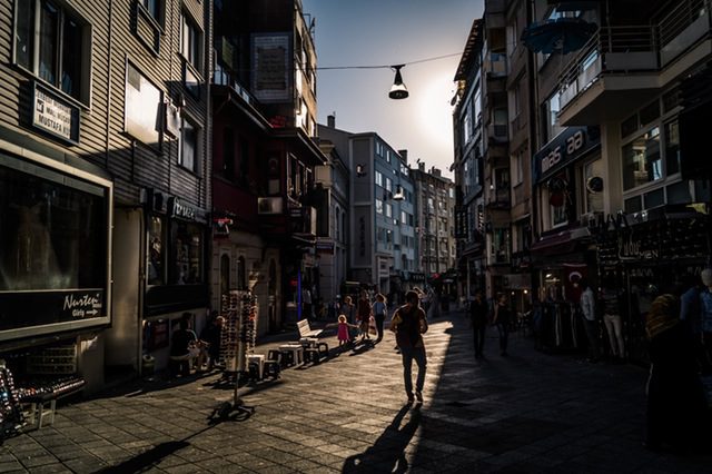 Person walking between buildings during daytime