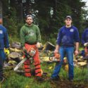 Four men outside with chainsaws